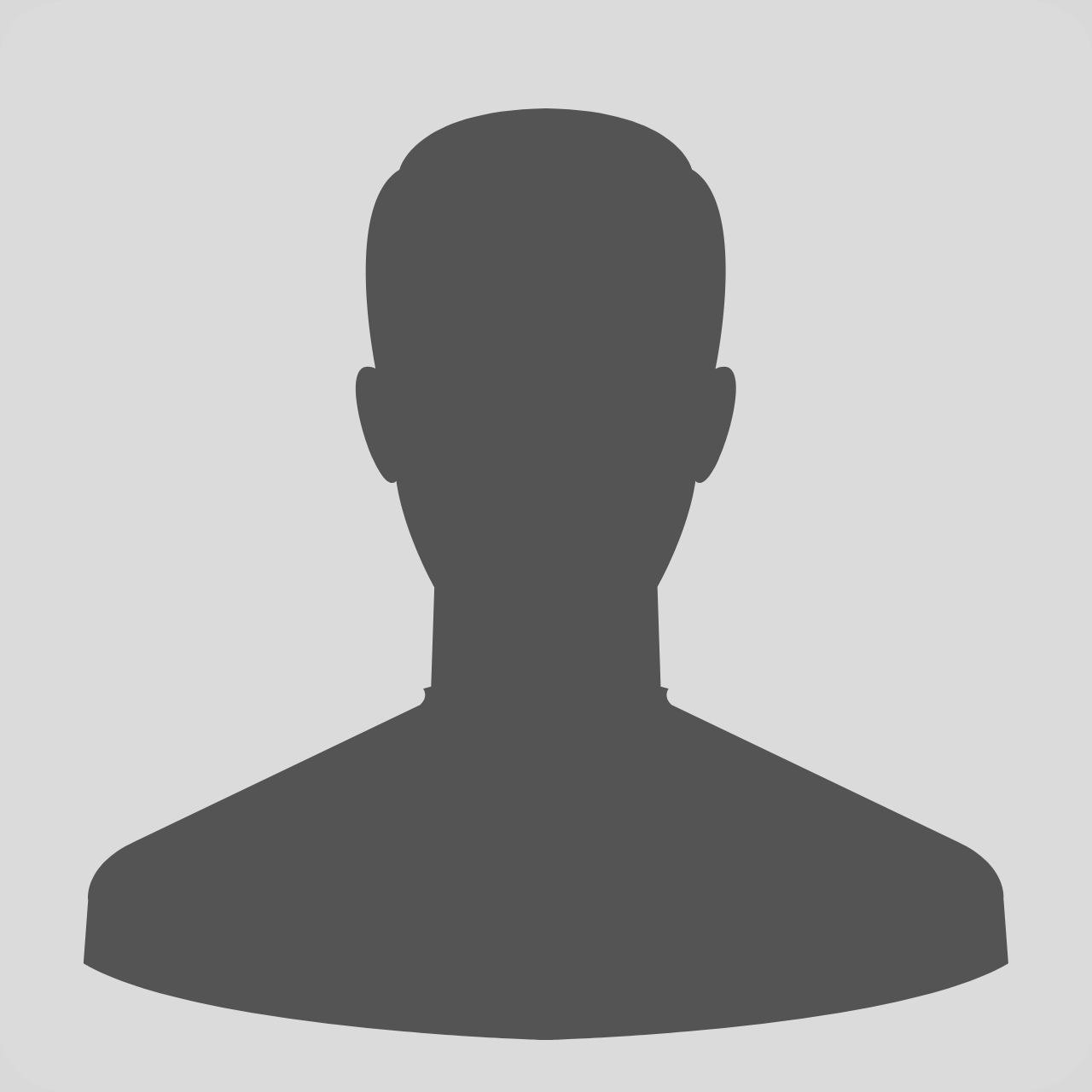 Young girls wearing white hijabs and blue skirts (their school uniforms) are smiling at the camera