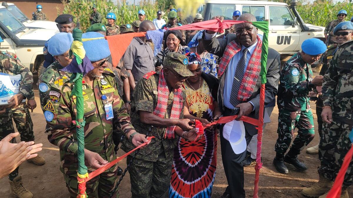 Representatives cut a commemorative ribbon together.